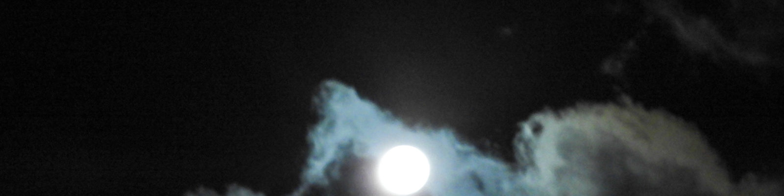 near full moon in clouds