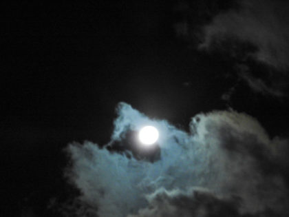 near full moon in clouds