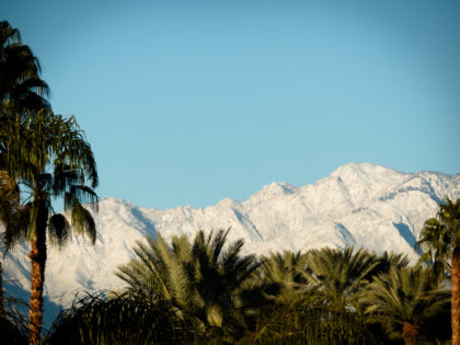 desert sunrise on snow covered mountains